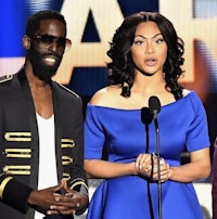 a man and a woman standing on stage at the bet awards