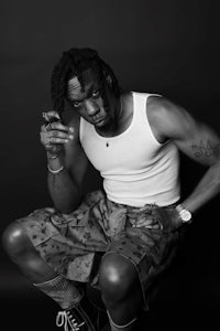 a black and white photo of a man smoking a cigarette