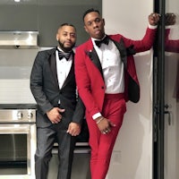 two men in tuxedos posing for a picture